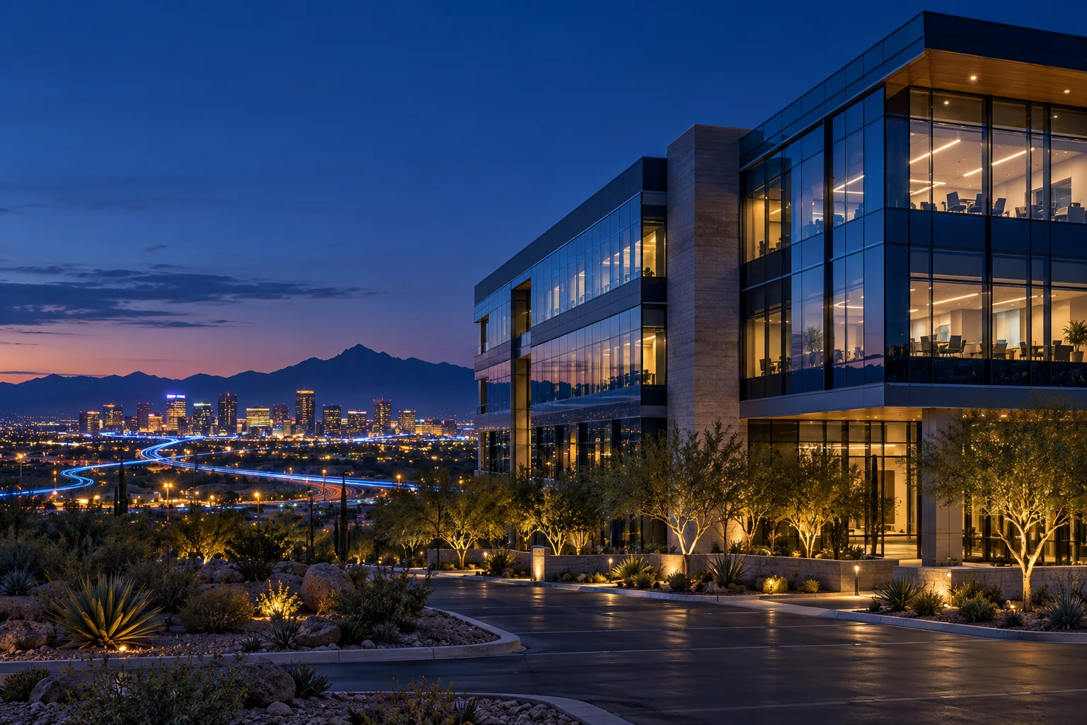 An office at dusk, with lights on in occupied rooms and dimmed in others